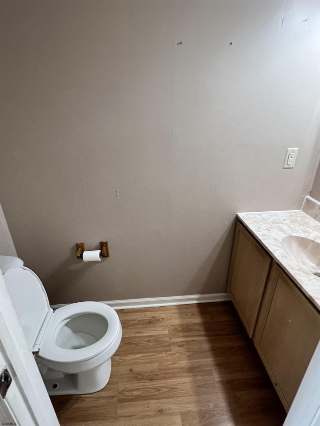 bathroom featuring vanity, hardwood / wood-style floors, and toilet