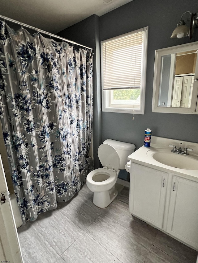 bathroom featuring vanity, toilet, and a shower with shower curtain