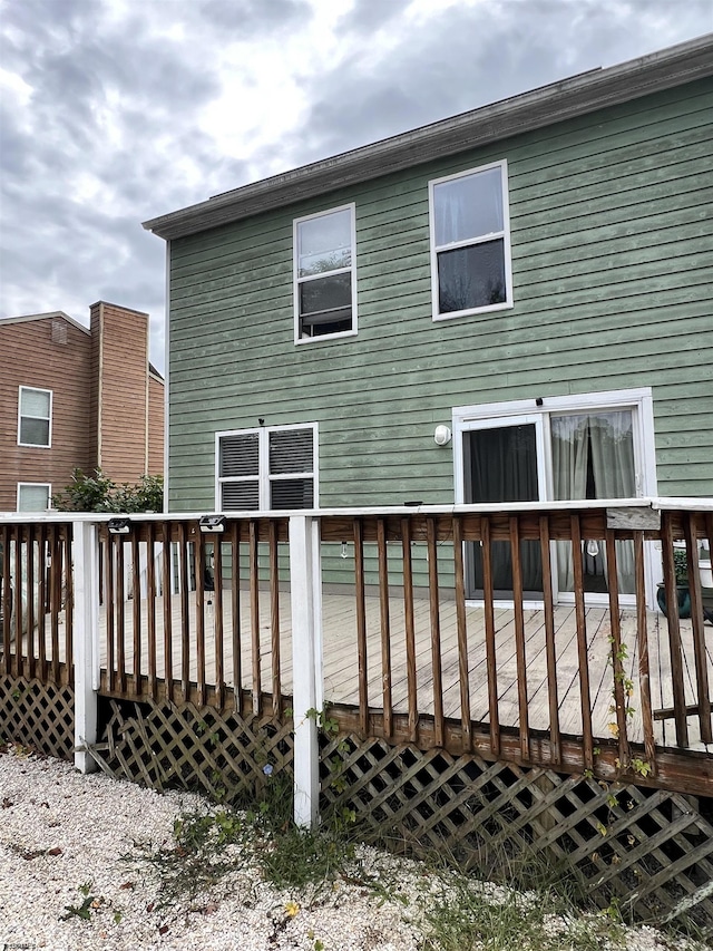 rear view of property featuring a wooden deck