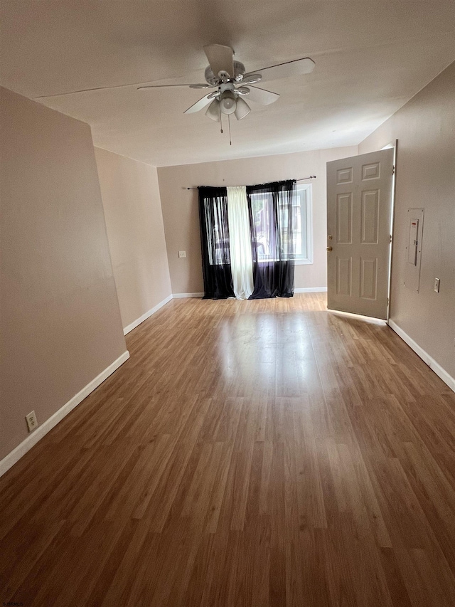 unfurnished room with hardwood / wood-style floors and ceiling fan