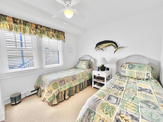 carpeted bedroom featuring a baseboard radiator and ceiling fan