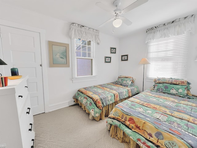 carpeted bedroom with multiple windows and ceiling fan