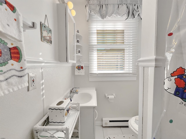 bathroom featuring baseboard heating, vanity, curtained shower, tile patterned floors, and toilet