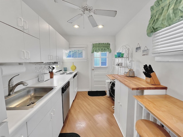 kitchen with white cabinetry, stainless steel dishwasher, light hardwood / wood-style floors, and sink