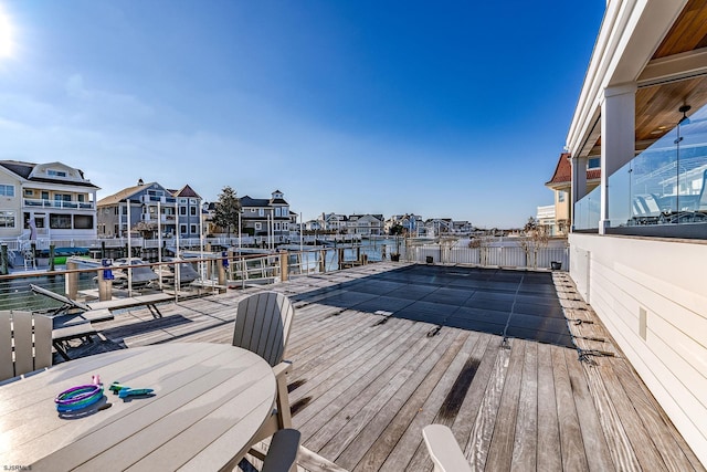 wooden terrace featuring a water view