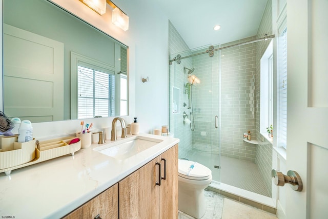 bathroom with vanity, toilet, and walk in shower