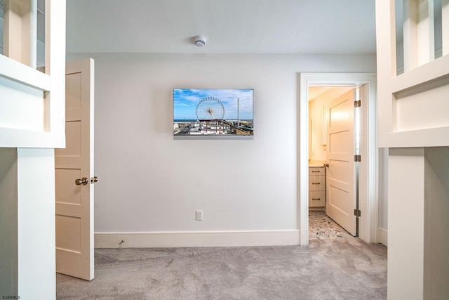 unfurnished bedroom featuring light carpet