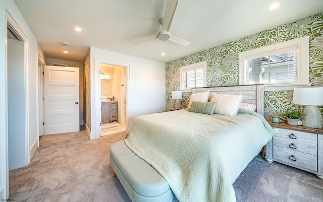 carpeted bedroom featuring ceiling fan and ensuite bathroom