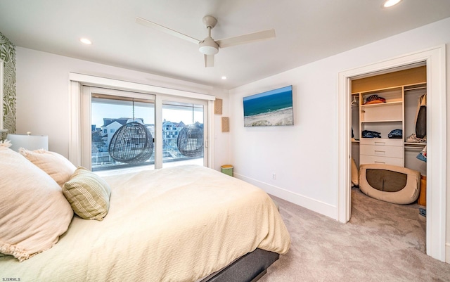 bedroom with a spacious closet, light carpet, a closet, ceiling fan, and access to exterior