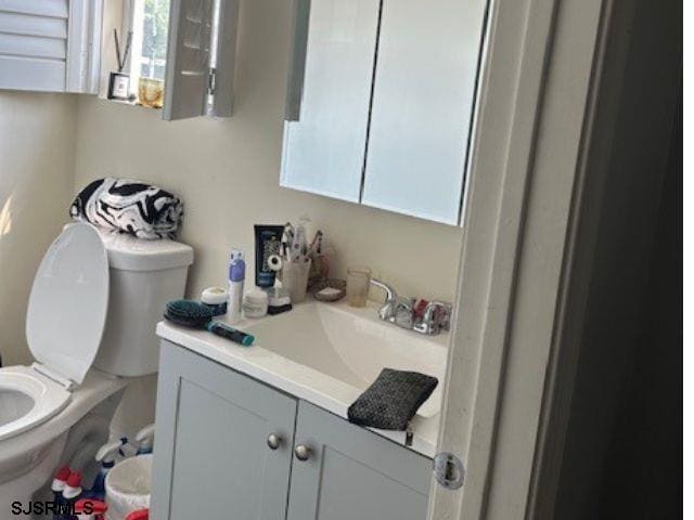 bathroom featuring vanity and toilet