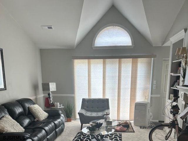 living room featuring vaulted ceiling and carpet floors