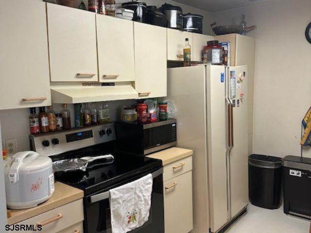 kitchen with white cabinets and appliances with stainless steel finishes