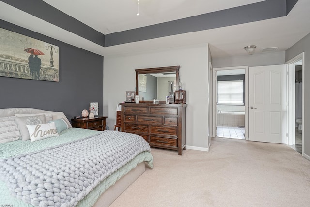 carpeted bedroom with ensuite bath