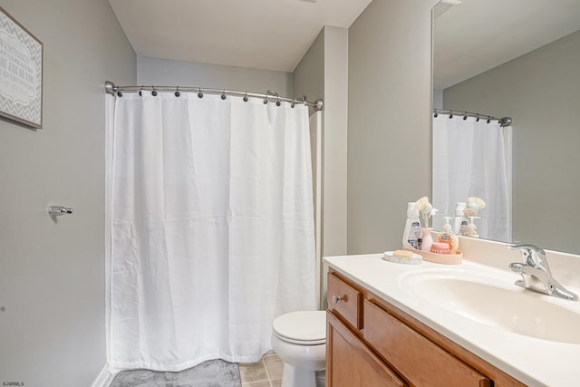 bathroom featuring vanity, tile patterned flooring, and toilet