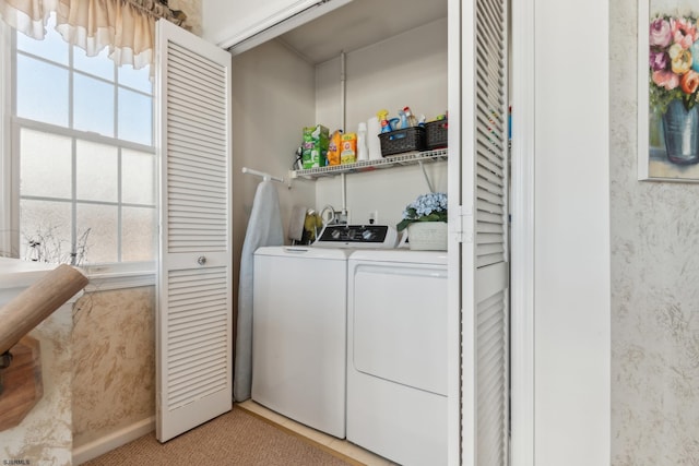 clothes washing area with washing machine and dryer