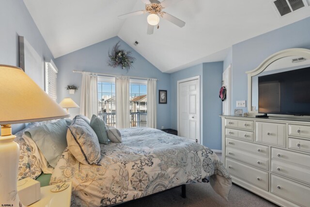 carpeted bedroom with vaulted ceiling, ceiling fan, and a closet