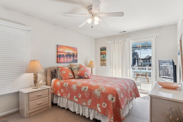 carpeted bedroom featuring ceiling fan and access to exterior