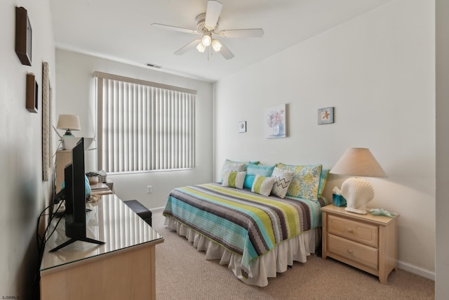 bedroom featuring light colored carpet and ceiling fan