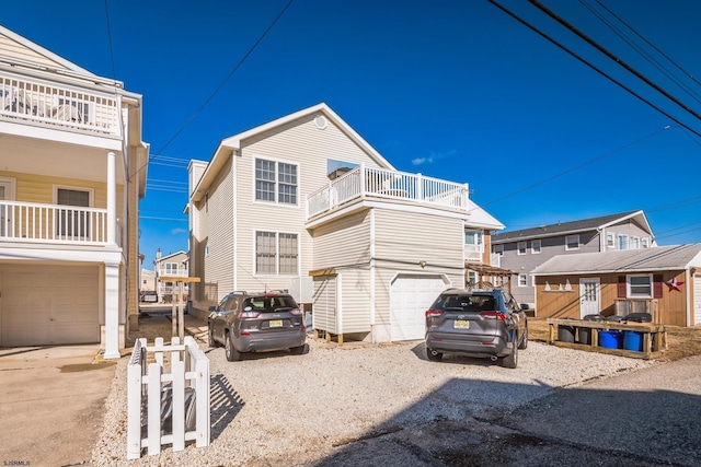 view of front facade featuring a garage and a balcony