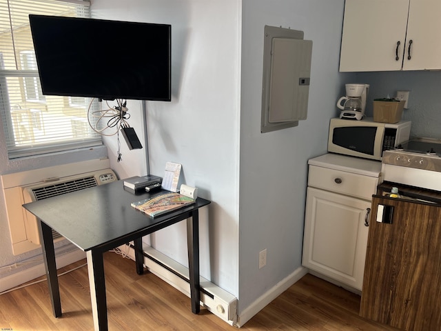 office area featuring electric panel and light wood-type flooring