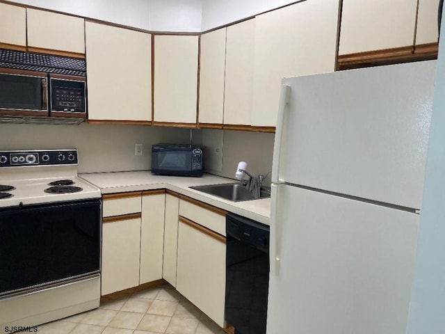 kitchen featuring white cabinetry, sink, black appliances, and light tile patterned flooring