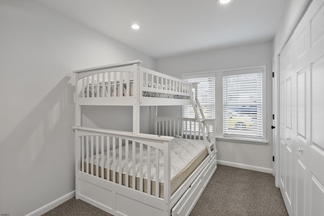 bedroom with a closet and dark colored carpet