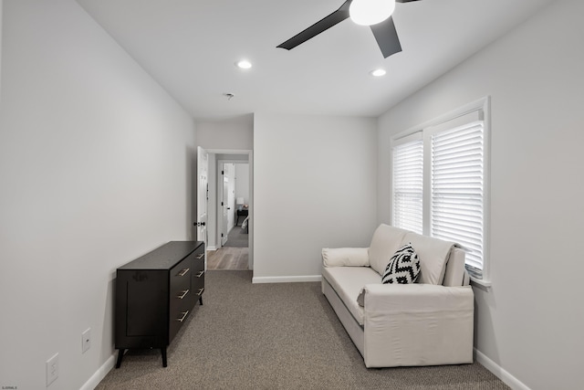 living area with ceiling fan and carpet flooring