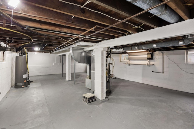 basement featuring heating unit and water heater