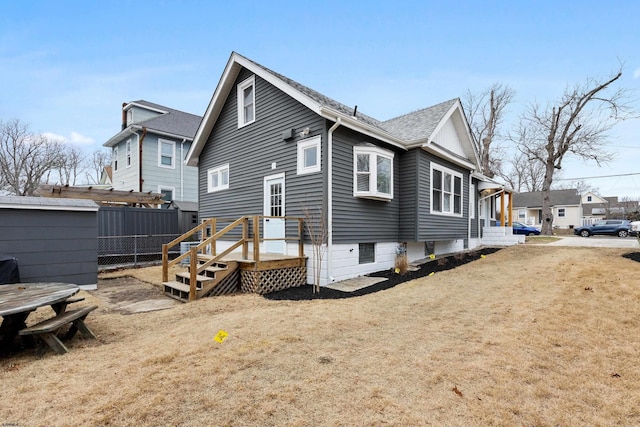 rear view of house featuring a yard