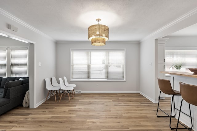 interior space with crown molding, plenty of natural light, and light wood-type flooring