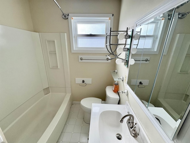 full bathroom with sink, tub / shower combination, tile patterned floors, and toilet