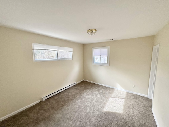 empty room featuring baseboard heating and carpet flooring