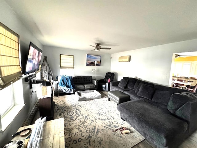 living room with wood-type flooring, a wealth of natural light, and ceiling fan