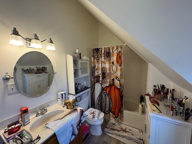 full bathroom featuring lofted ceiling, sink, shower / bath combo, hardwood / wood-style floors, and toilet