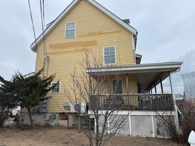 rear view of property with a porch