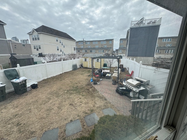 view of yard with a shed and a patio area