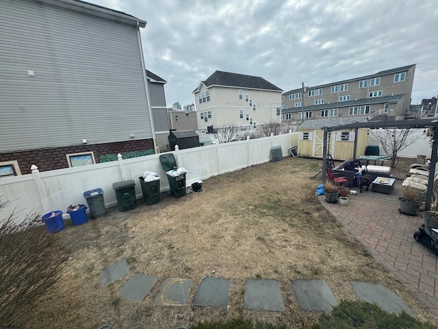 view of yard with a patio and a storage unit