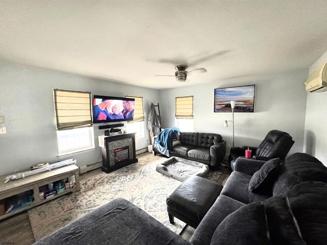 living room with ceiling fan and a baseboard heating unit