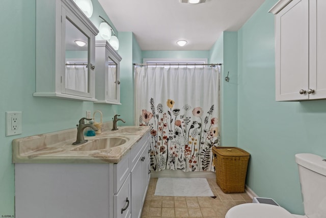 bathroom featuring walk in shower, vanity, and toilet