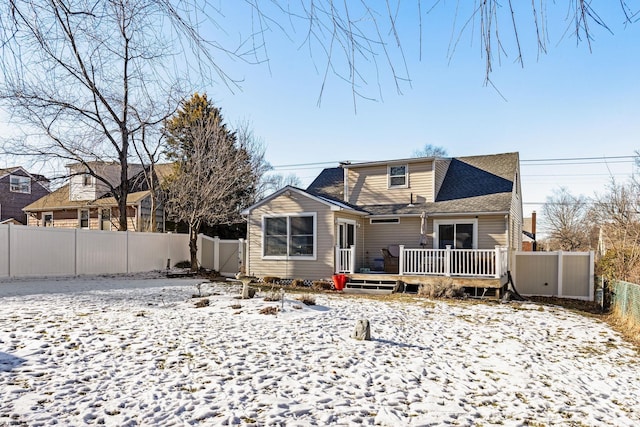 snow covered property featuring a wooden deck