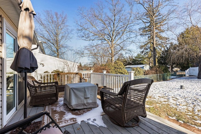 snow covered deck with a grill