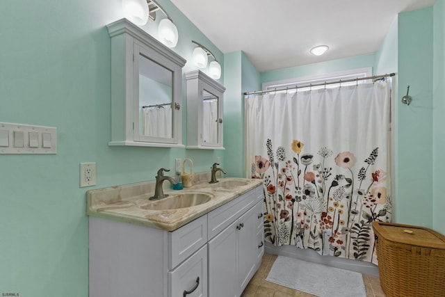 bathroom with walk in shower, tile patterned floors, and vanity