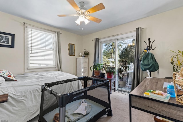 carpeted bedroom with ceiling fan and access to outside