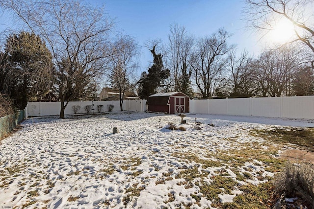 snowy yard with a shed