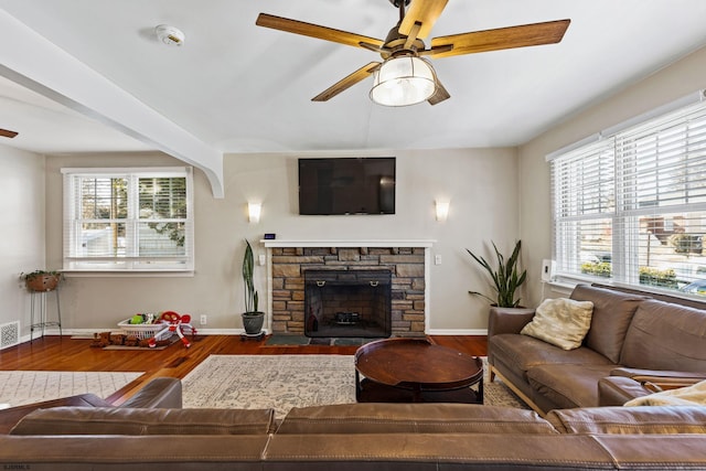 living room with ceiling fan, a fireplace, and dark hardwood / wood-style floors