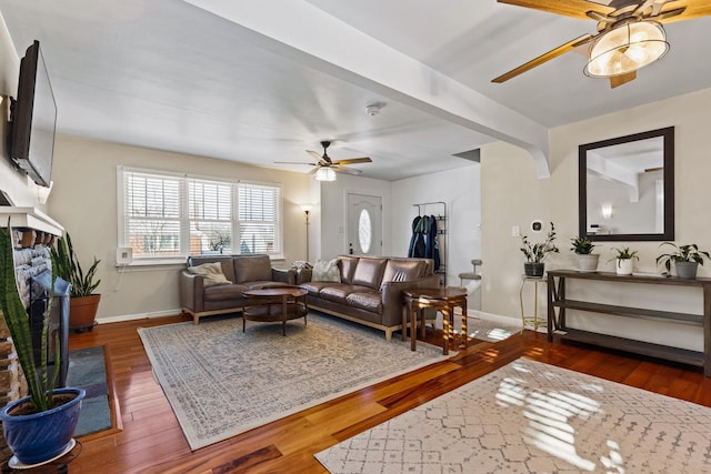 living room with ceiling fan and dark hardwood / wood-style flooring