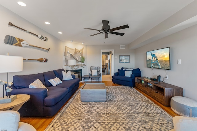 living room with hardwood / wood-style flooring and ceiling fan