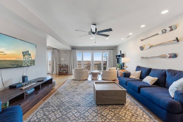 living room with hardwood / wood-style flooring and ceiling fan