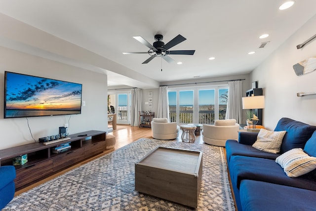 living room with ceiling fan and hardwood / wood-style floors