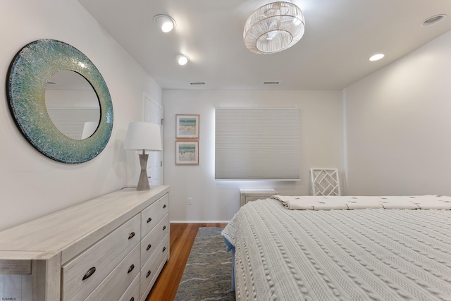 bedroom with dark hardwood / wood-style flooring